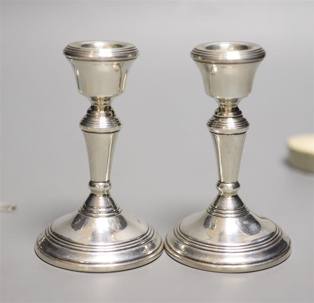 A pair of modern silver dwarf candlesticks, London, 1977, 10.6cm, weighted, two silver condiments, etc.